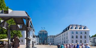 Eine Besuchergruppe auf den Platz vor dem Saarbrücker Schloss. (Foto: IMAGO / Volker Preußer)